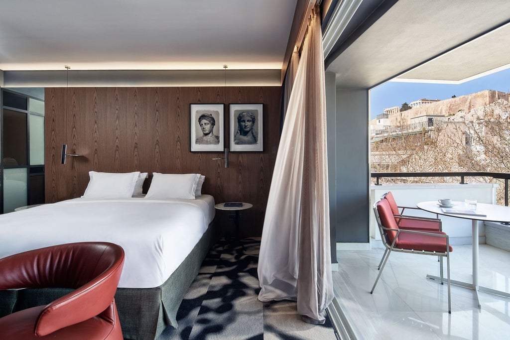 Elegant hotel facade with floor-to-ceiling glass windows, sleek stone exterior and modern architectural details in central Athens, Greece