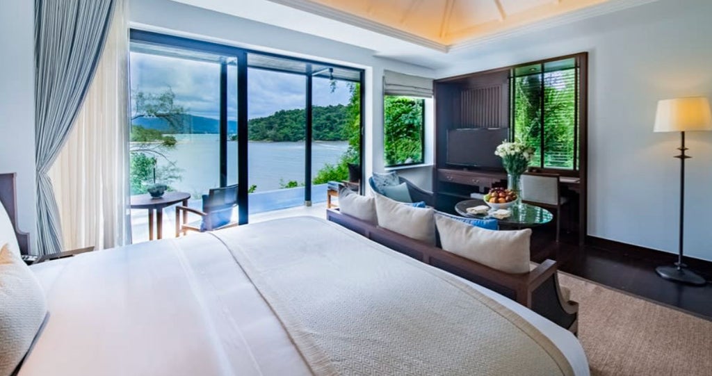 Luxurious pool suite with private infinity pool overlooking Layan Beach, featuring modern Thai decor and panoramic Andaman Sea views