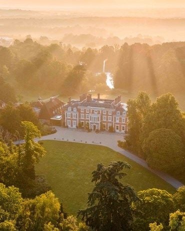 Serene Georgian manor nestled in Hampshire's verdant landscape, showcasing elegant architecture, manicured gardens, and timeless luxury of a countryside retreat