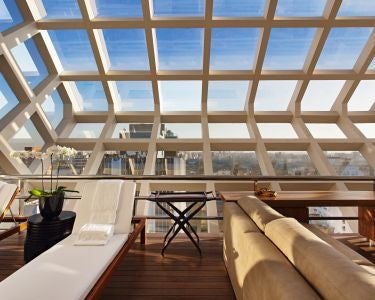 Luxurious modern hotel room with sleek design, floor-to-ceiling windows overlooking São Paulo's cityscape, featuring minimalist furniture and elegant neutral tones