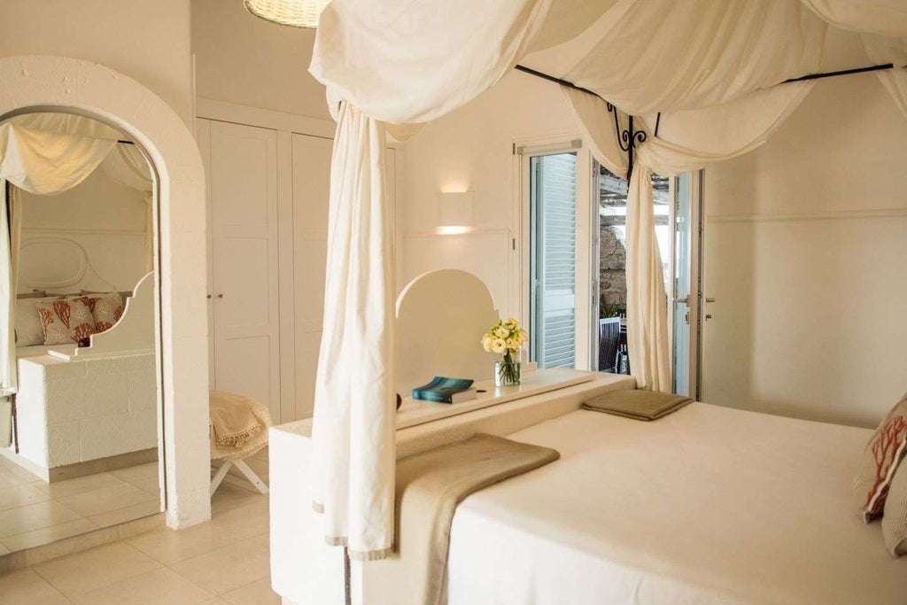 Elegant sunrise-lit bedroom in La Peschiera Hotel, Italy, with crisp white linens, panoramic sea view, and minimalist modern design