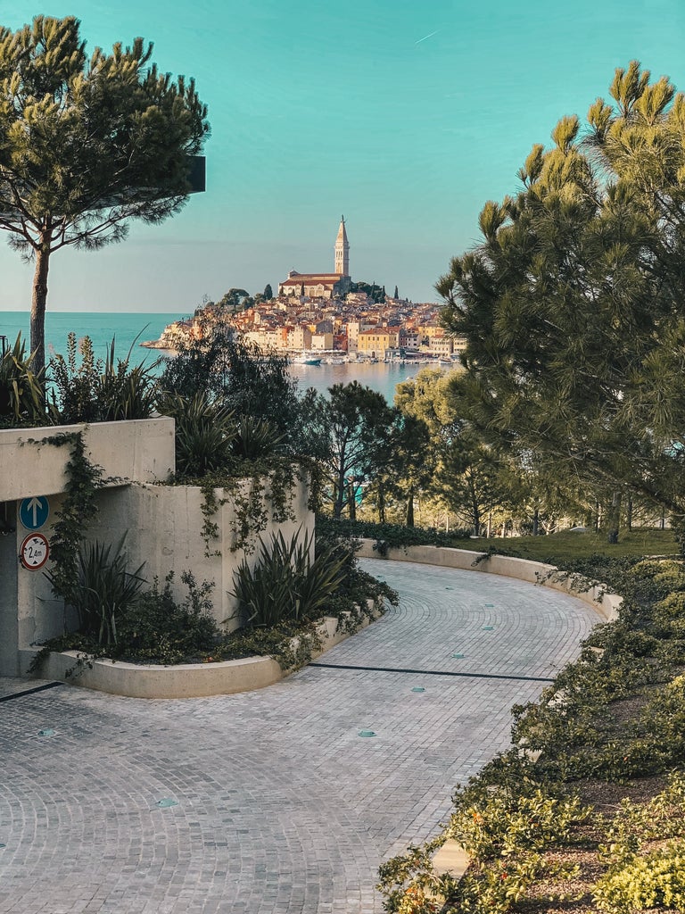 People explore narrow cobblestone streets in Rovinj's old town before joining a gourmet cooking class in a traditional stone villa