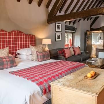 Elegant single room at The Lygon Arms Main House, featuring plush bedding, warm wood furnishings, and soft neutral color palette in a historic British setting