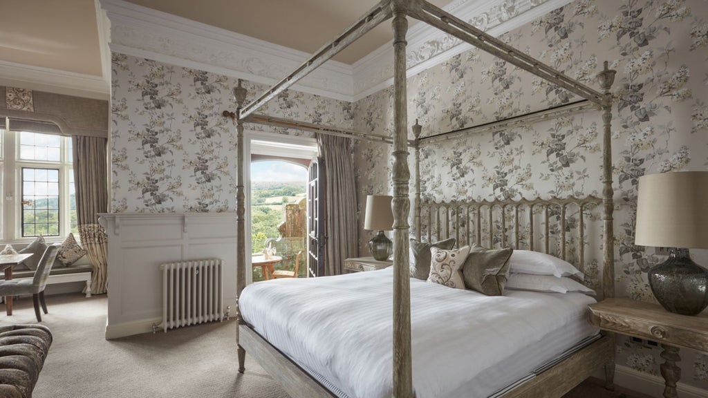 Opulent grand state room at Bovey Castle Hotel and Spa, featuring elegant period furnishings, rich wooden paneling, and expansive views of manicured countryside