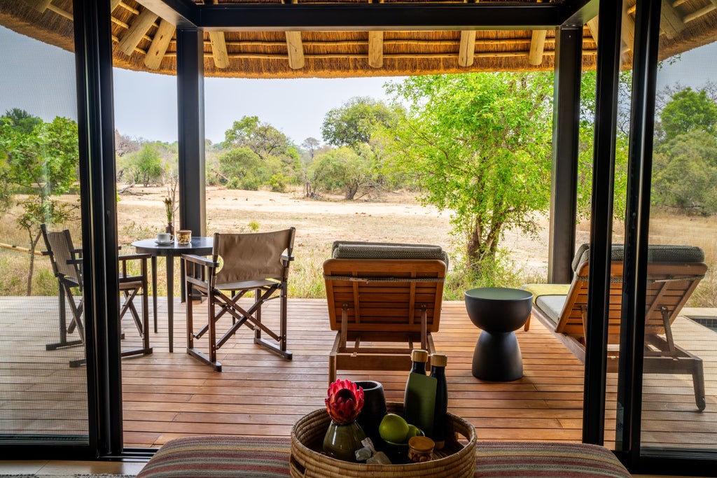 Private luxury lodge in South African bush with thatched roof villa and infinity pool overlooking natural savanna landscape