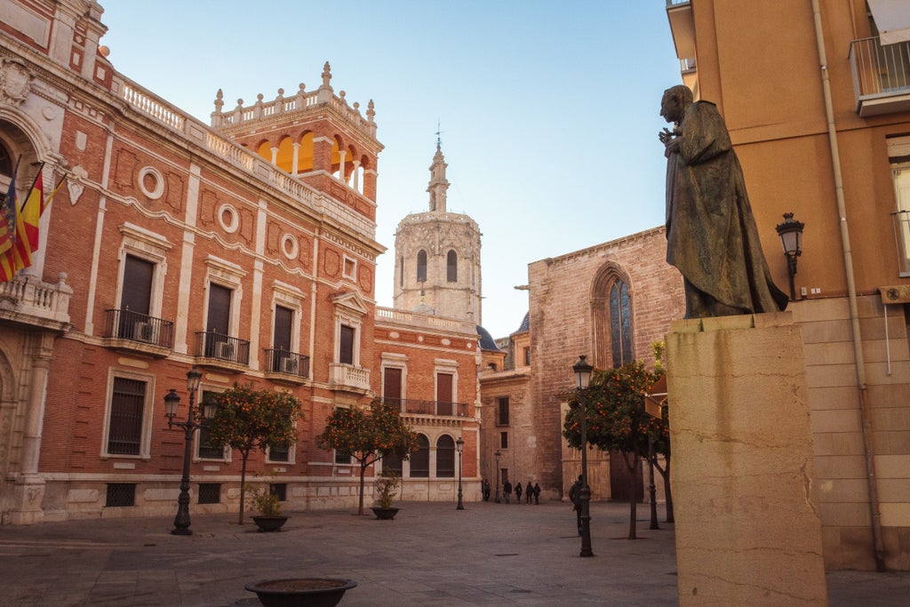 Cobblestone streets of Old Valencia's historic center, sunlight casting golden hues on ornate medieval architecture and vibrant Mediterranean charm