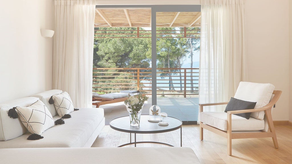 Luxurious minimalist NEST Suite at ELIVI Skiathos hotel, featuring white interiors, sleek design, and panoramic views of the Aegean Sea in Greece