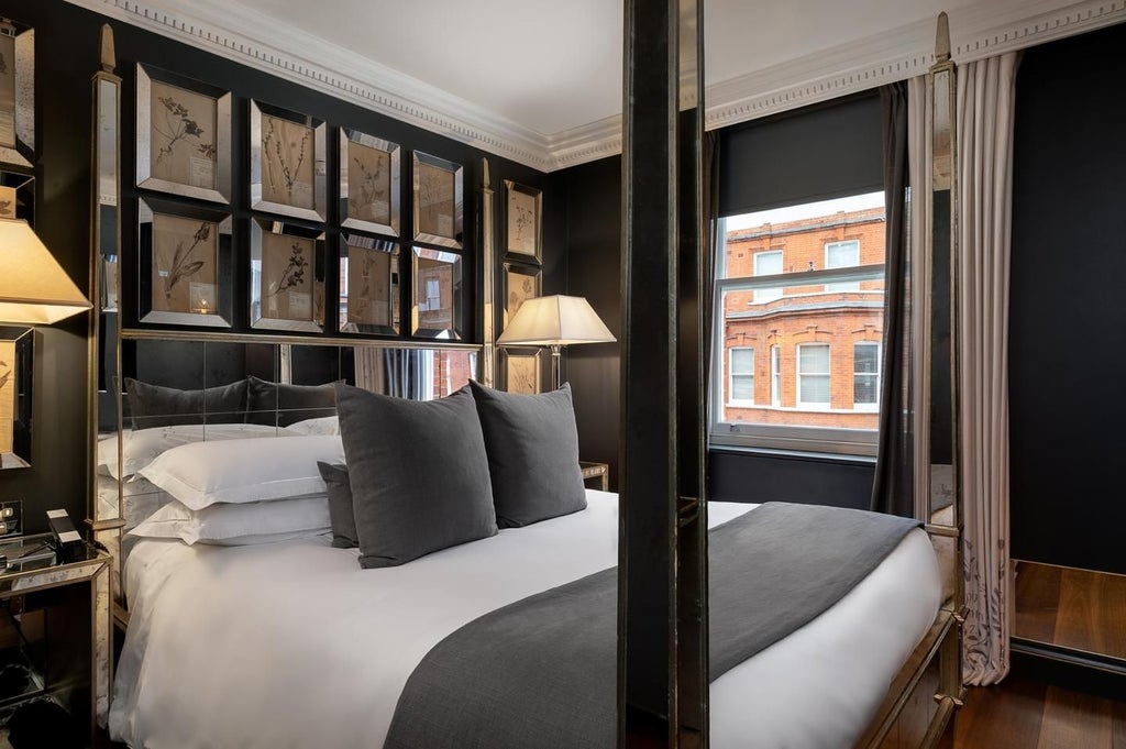 Luxurious executive suite with elegant king bed, plush white linens, modern minimalist decor, large windows overlooking city skyline in United Kingdom hotel