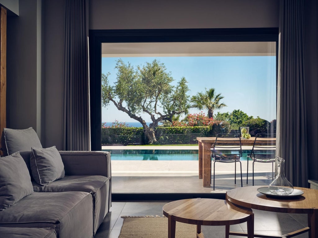 Luxurious white-washed Greek villa bedroom with panoramic Aegean Sea view, elegant minimalist design, private balcony, and sunlight streaming across marble floors