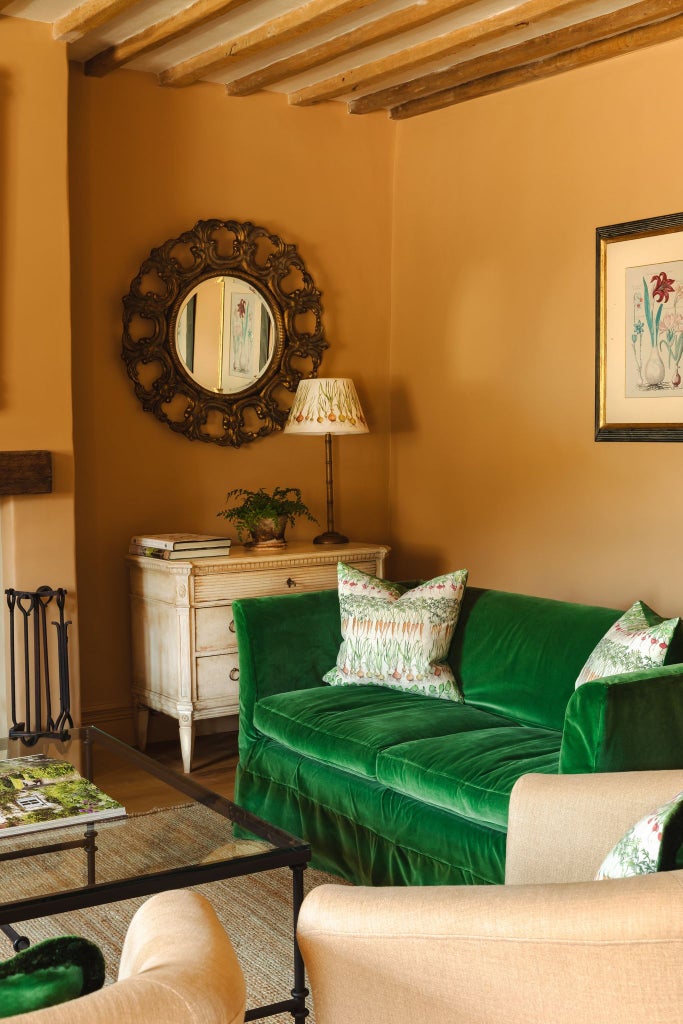 Cozy luxury cottage bedroom with soft linens, rustic wooden furniture, and warm thyme-green accents in a tranquil United Kingdom countryside setting