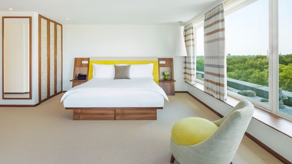 Elegant COMO Suite with contemporary design, plush king bed, luxurious gray and white color palette, city view window overlooking metropolitan London skyline