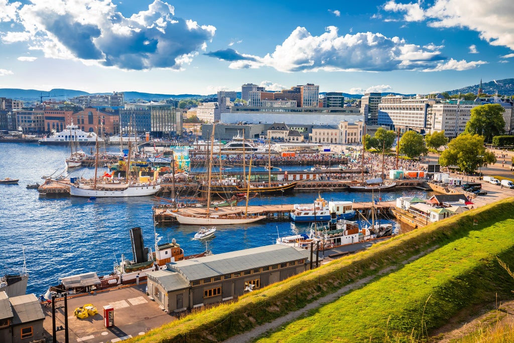 Historic Oslo cityscape with elegant cobblestone streets, vibrant traditional architecture, and lush greenery showcasing Norwegian urban charm during a guided walking exploration.