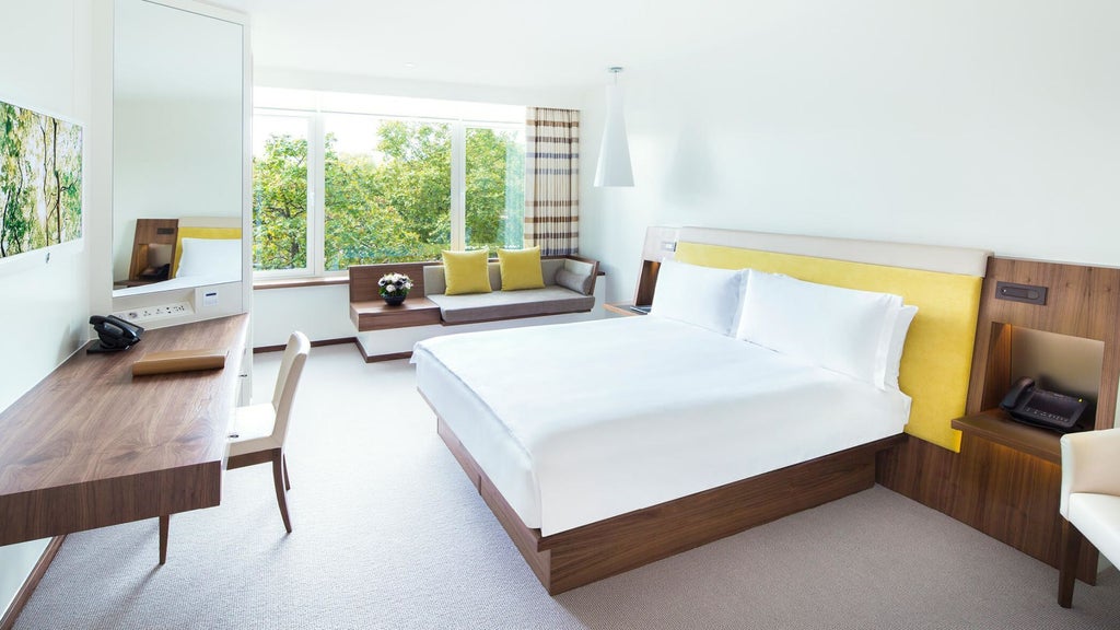 Luxurious COMO Suite at COMO Metropolitan London with contemporary design, plush king bed, city-view windows, and elegant neutral color palette.