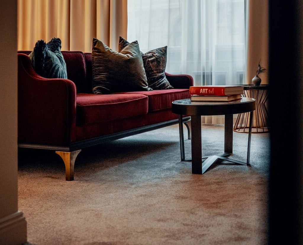 Luxurious minimalist hotel room with clean white linens, elegant wooden furniture, and soft natural light illuminating modern Scandinavian design aesthetic