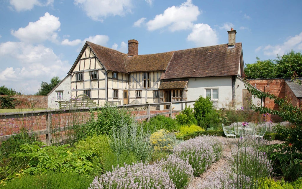 Elegant stone-and-glass manor hotel nestled in lush countryside, featuring modern architectural design with traditional British countryside charm