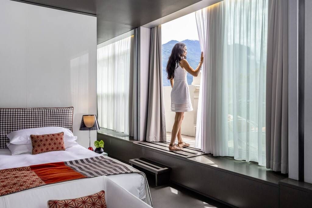 Luxurious sky signature suite at Lido Palace, featuring elegant contemporary design with panoramic windows overlooking stunning Italian landscape and pristine interior decor