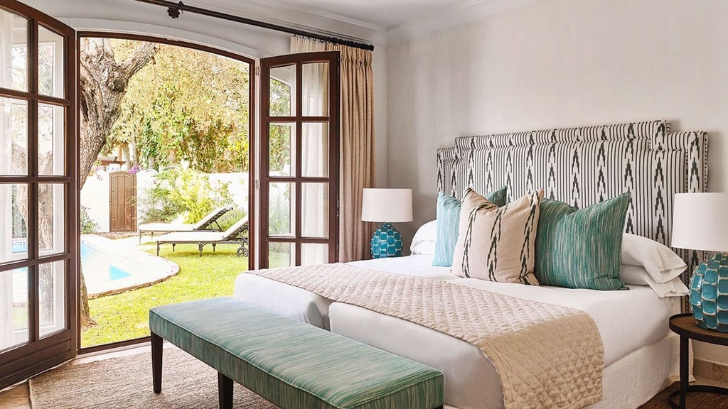 Luxurious two-bedroom bungalow at Marbella Club, featuring elegant white interiors, plush furnishings, and soft natural light streaming through windows.