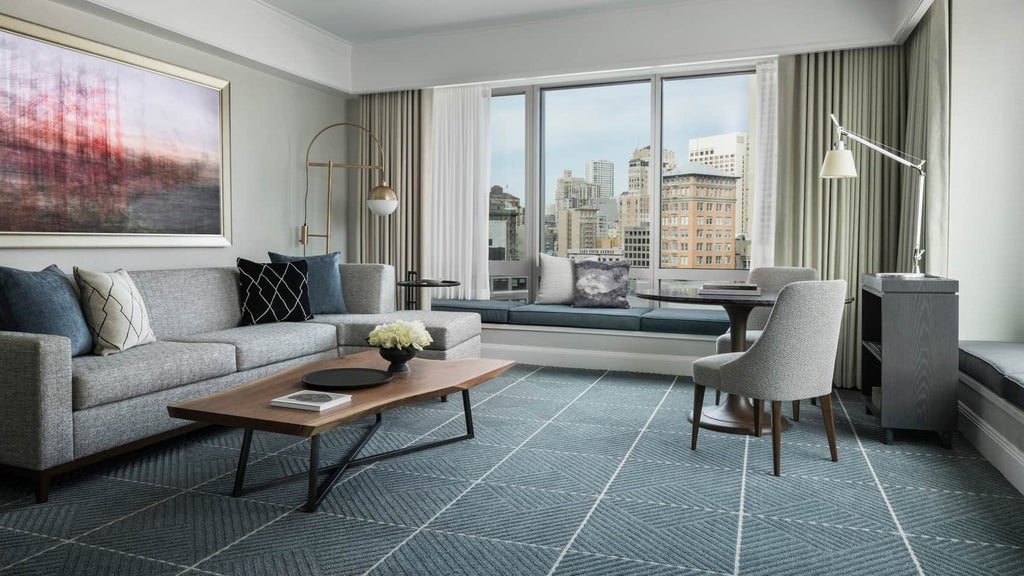 Luxurious deluxe suite with panoramic city views, featuring elegant modern decor, king bed, marble bathroom, and floor-to-ceiling windows overlooking scenset skyline