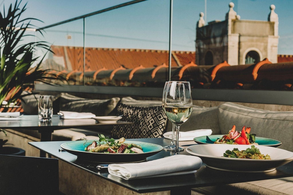 Luxury boutique hotel in Lisbon's historic district, featuring elegant white exterior, traditional Portuguese architecture, and charming balconies overlooking cobblestone streets.