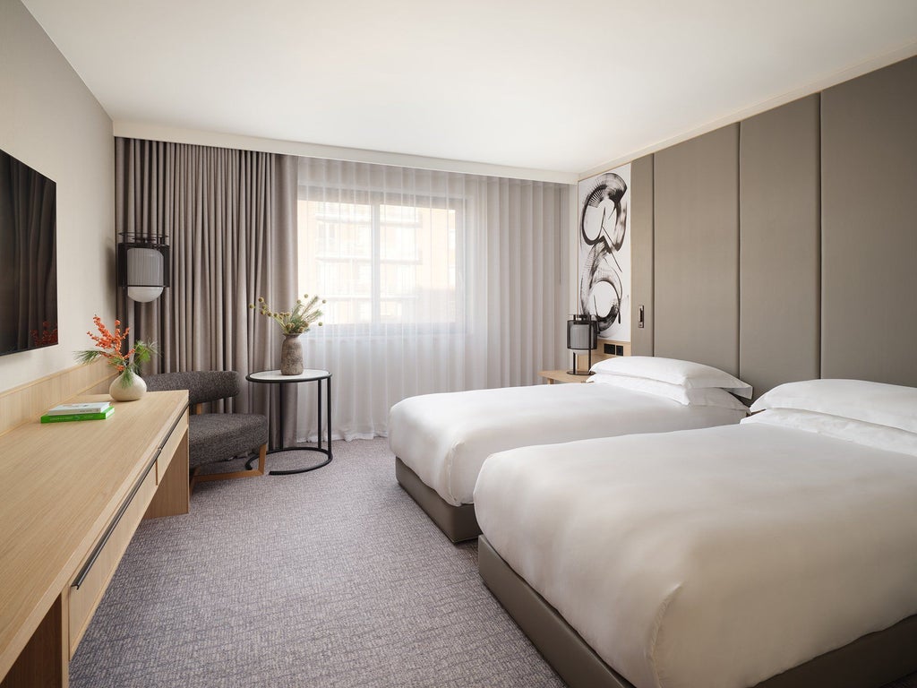 Luxurious family deluxe room at Scenset Hotel London Portman Square, featuring elegant decor, spacious balcony, and contemporary design with city views