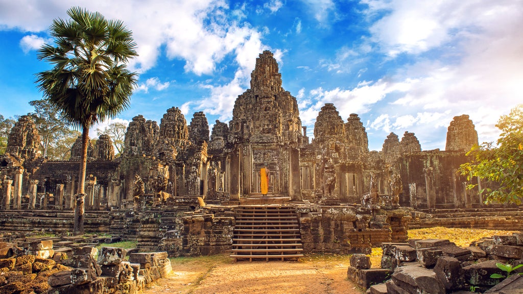 Ancient stone temple complex with intricate carvings, lush green forest backdrop, golden light illuminating sandstone structures of Angkor Wat's majestic architecture at dawn