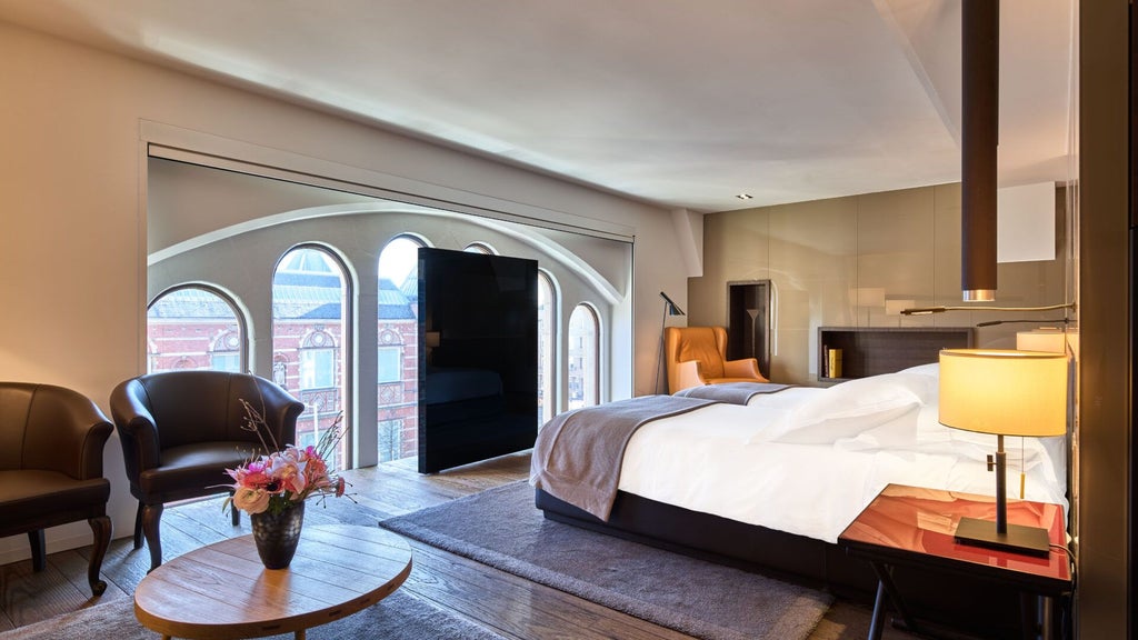 Luxurious two-bedroom suite at Scenset Conservatorium Hotel, Amsterdam, featuring elegant design with modern furniture and warm, sophisticated lighting