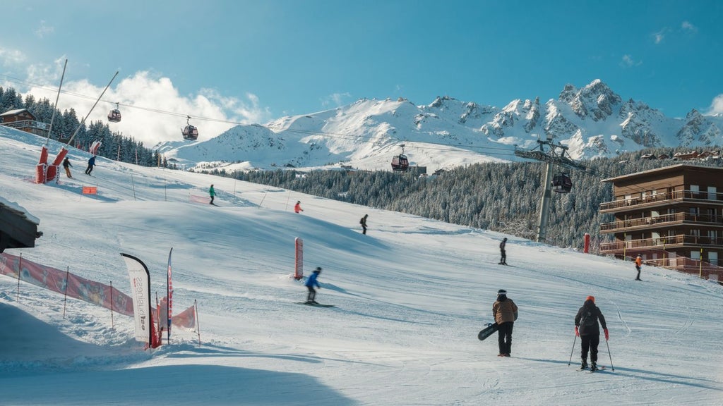 Luxurious alpine ski resort hotel nestled in French mountains, featuring contemporary chalet-style architecture with snow-capped peaks and elegant wooden balconies