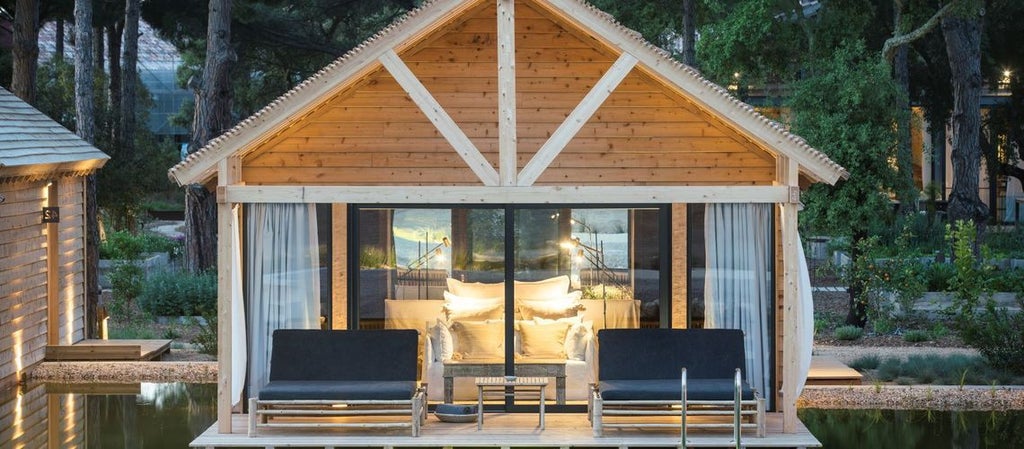 Minimalist luxury bio pool suite at Sublime Comporta Hotel with natural wood, crisp white linens, and serene Portuguese coastal landscape view