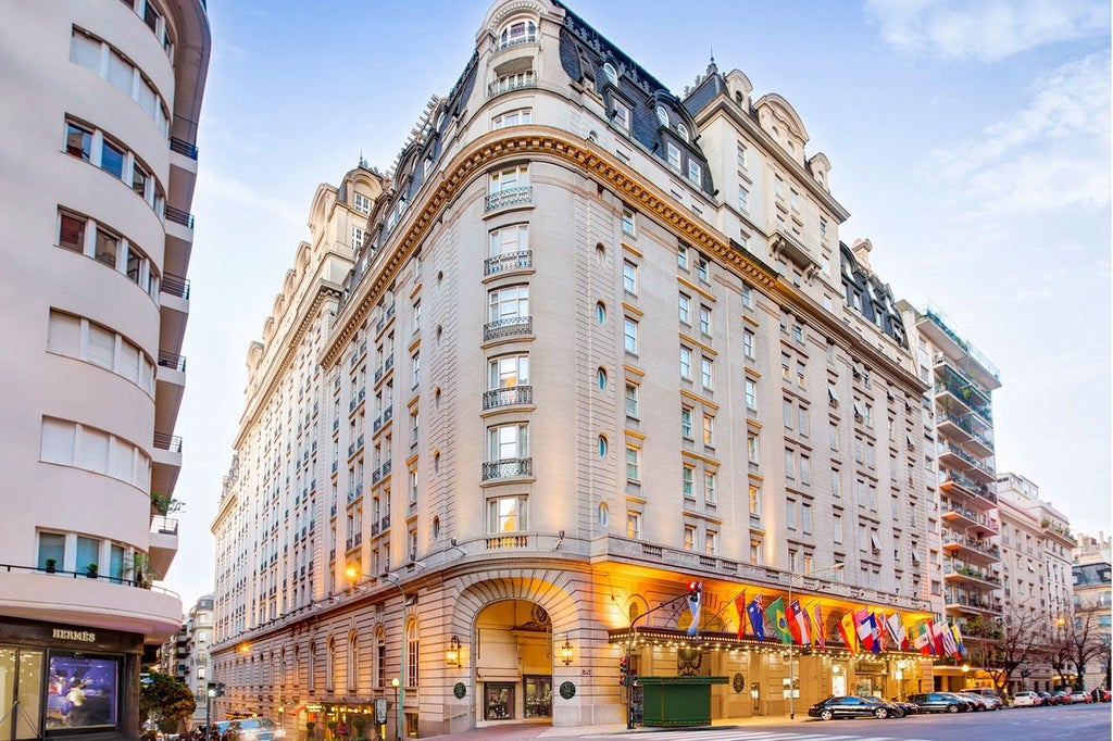 Majestic neoclassical Alvear Palace Hotel facade with ornate white stone details, French balconies, and elegant entrance canopy in Buenos Aires