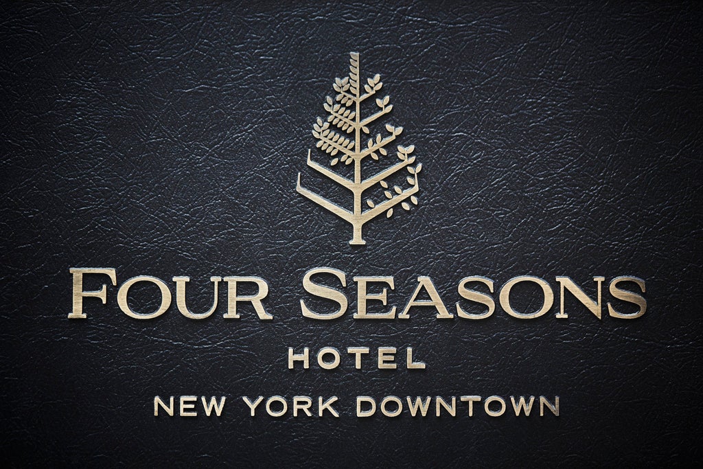 Luxurious Four Seasons hotel exterior in downtown Manhattan features glass facade, modern architecture and grand entrance canopy at dusk