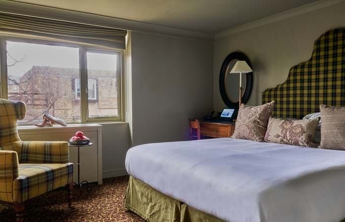 Charming cosy single room at The Lygon Arms hotel, featuring elegant traditional decor with soft neutral tones and classic British countryside styling.