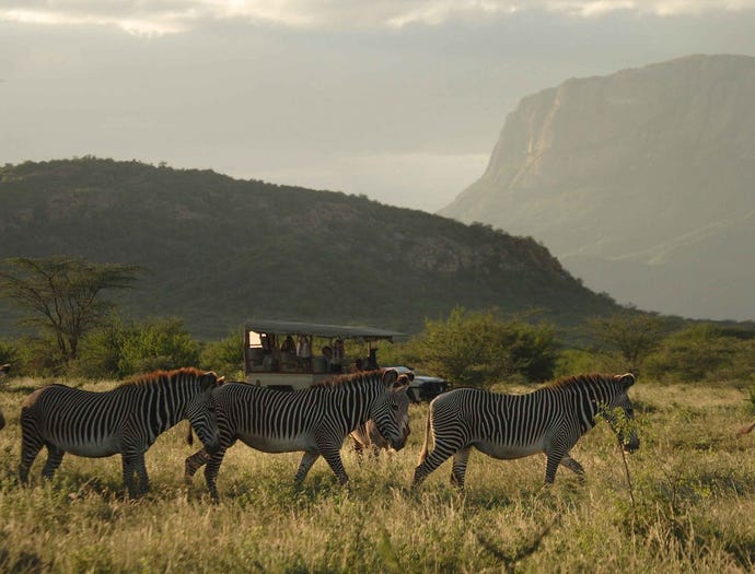 One of Saruni's open safari vehicles with Mount Ololokwe in the backdrop