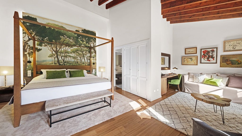 Elegant junior suite with crisp white linens, warm wood furnishings, and large window overlooking scenic landscape in Scenset hotel in Spain