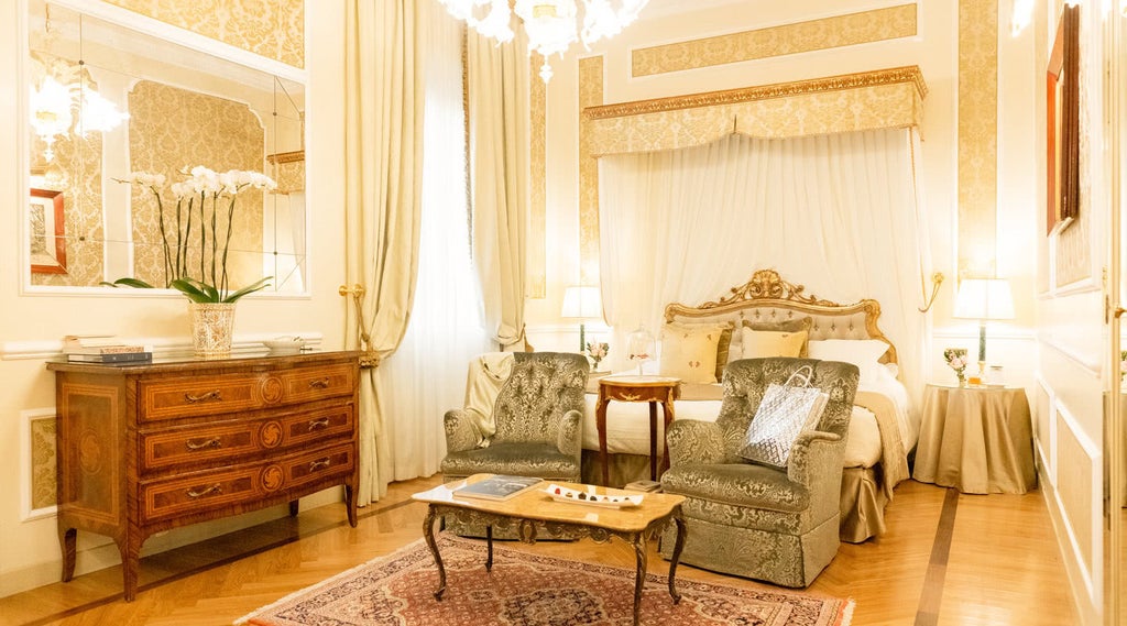 Elegant marble lobby of historic Grand Hotel Majestic Bologna featuring crystal chandeliers, ornate columns and plush red carpeting