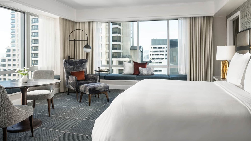 Luxurious premier hotel room with modern minimalist design, featuring plush king bed, city view windows, and elegant contemporary furnishings in a neutral color palette