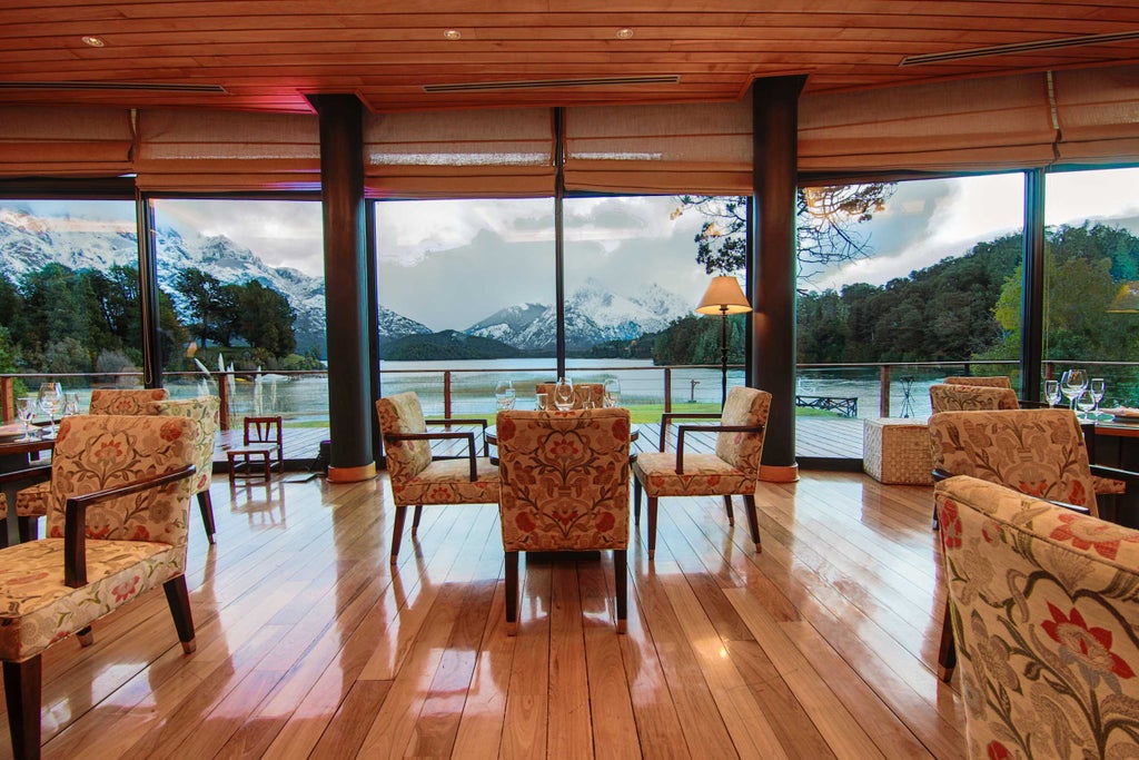 Luxurious alpine-style resort nestled between snow-capped Andes mountains and pristine lakes, featuring timber architecture and manicured gardens