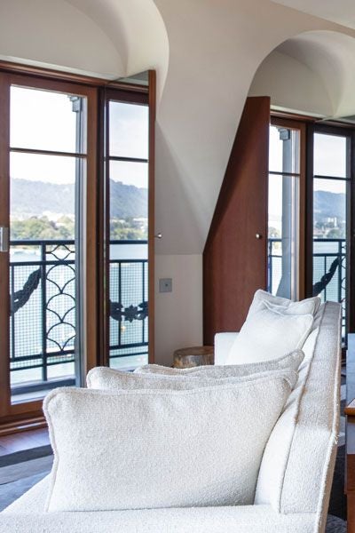 Elegant lake view suite at La Réserve Eden au Lac Zurich, featuring panoramic Swiss lake scenery, modern minimalist design, and plush neutral-toned furnishings