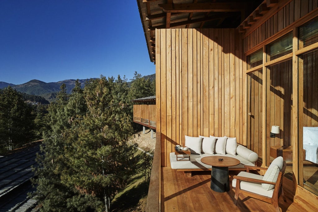 Upscale lodge nestled in pine forest with timber facade, floor-to-ceiling windows, and wraparound deck overlooking Bhutanese mountains