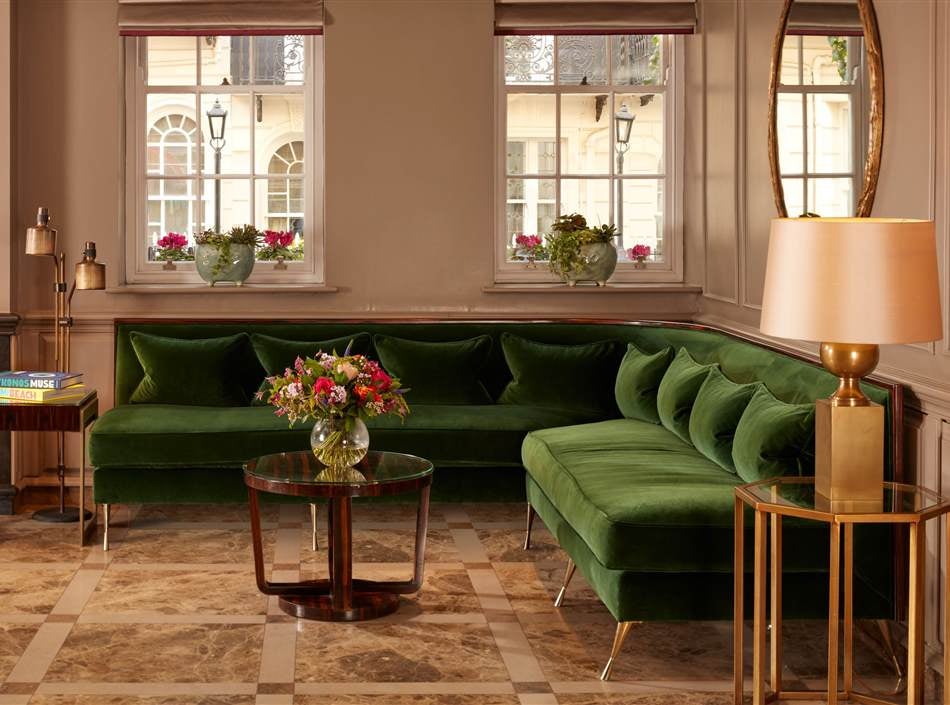 Elegant Flemings Mayfair Hotel exterior featuring classic Georgian architecture, wrought-iron railings, and manicured window boxes in London