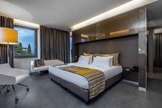 Elegant Deluxe Studio at Lido Palace with panoramic park views, featuring plush modern furnishings, soft neutral tones, and expansive floor-to-ceiling windows