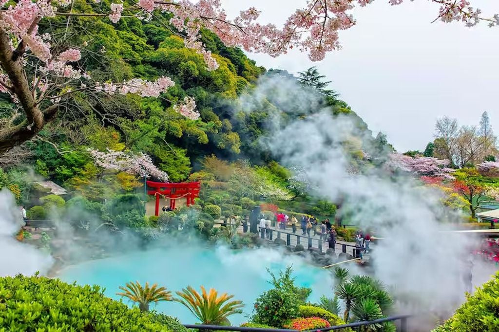 Luxurious Beppu hot springs tour featuring traditional Japanese onsen, steaming volcanic landscapes, and elegant ryokan architecture in vibrant afternoon light