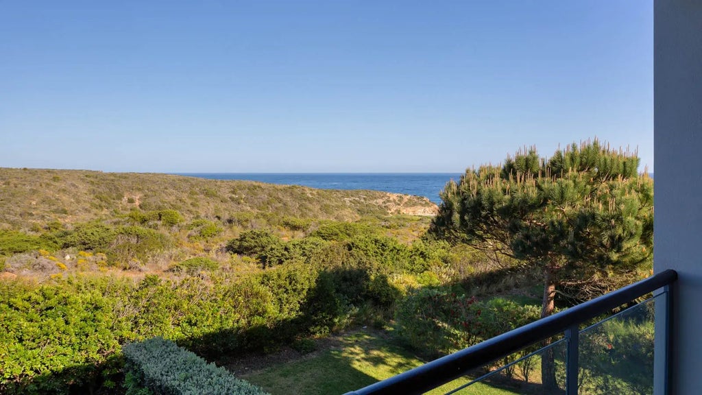 Elegant Bay House suite at Martinhal Sagres Beach Resort, featuring contemporary design, panoramic ocean views, and minimalist luxurious coastal Portuguese interior.