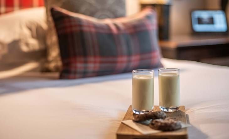 Elegant superior room at The Lygon Arms, featuring plush bedding, classic British décor, and warm wooden furnishings with refined country hotel ambiance