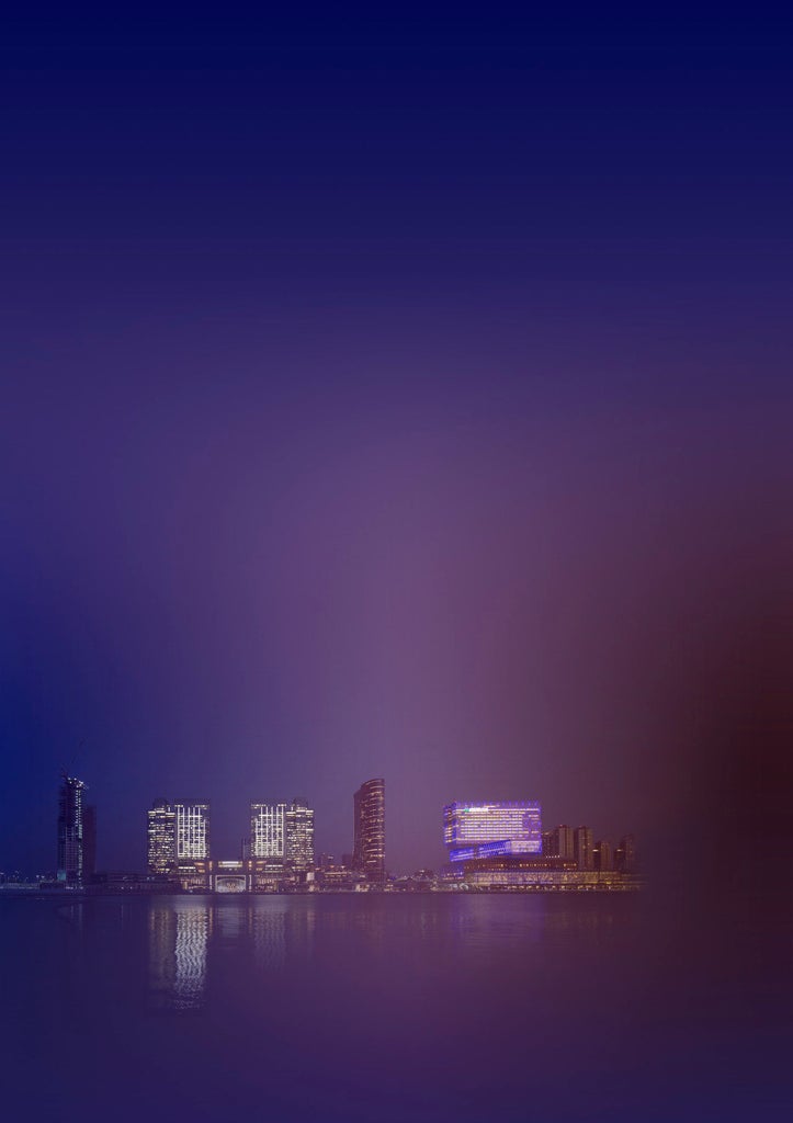 Four Seasons Hotel Abu Dhabi's sleek glass facade reflects sunset light, towering over Al Maryah Island's waterfront with luxury terraces