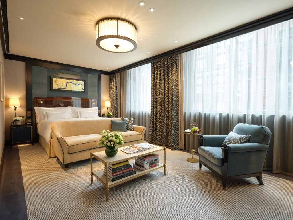 Luxurious superior studio in Mayfair hotel with elegant contemporary furnishings, soft neutral tones, plush king bed, and sleek marble-accented bathroom