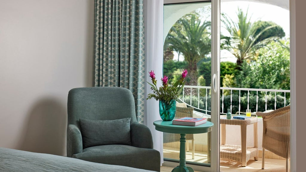 Elegant premium suite with panoramic ocean view, plush white furnishings, modern coastal design, and luxurious spacious interior at Vila Vita Parc Resort in Algarve, Portugal