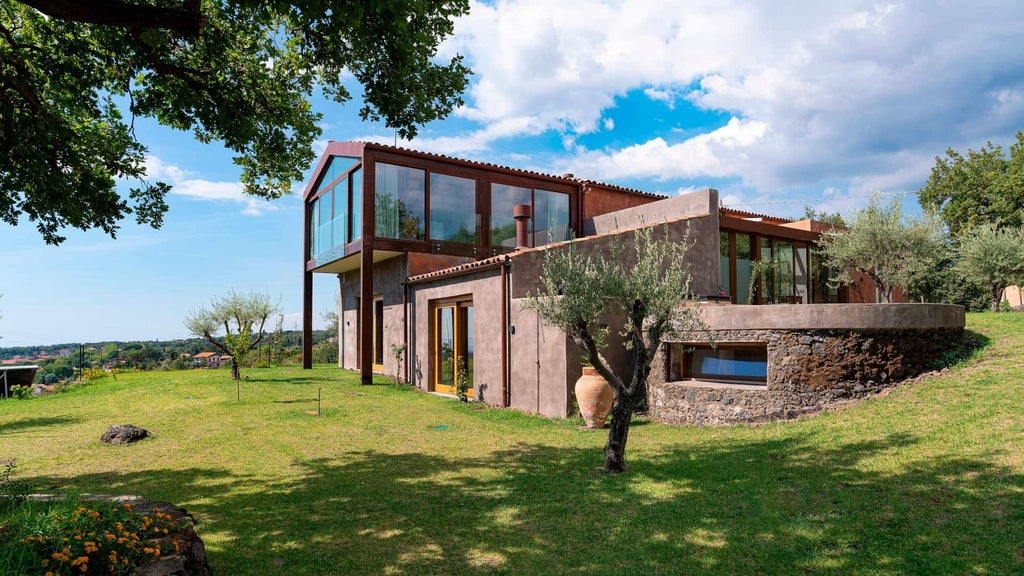 Luxurious estate pool suite with rustic stone walls, terracotta tiles, and elegant loungers overlooking verdant Sicilian landscape at Scenset retreat