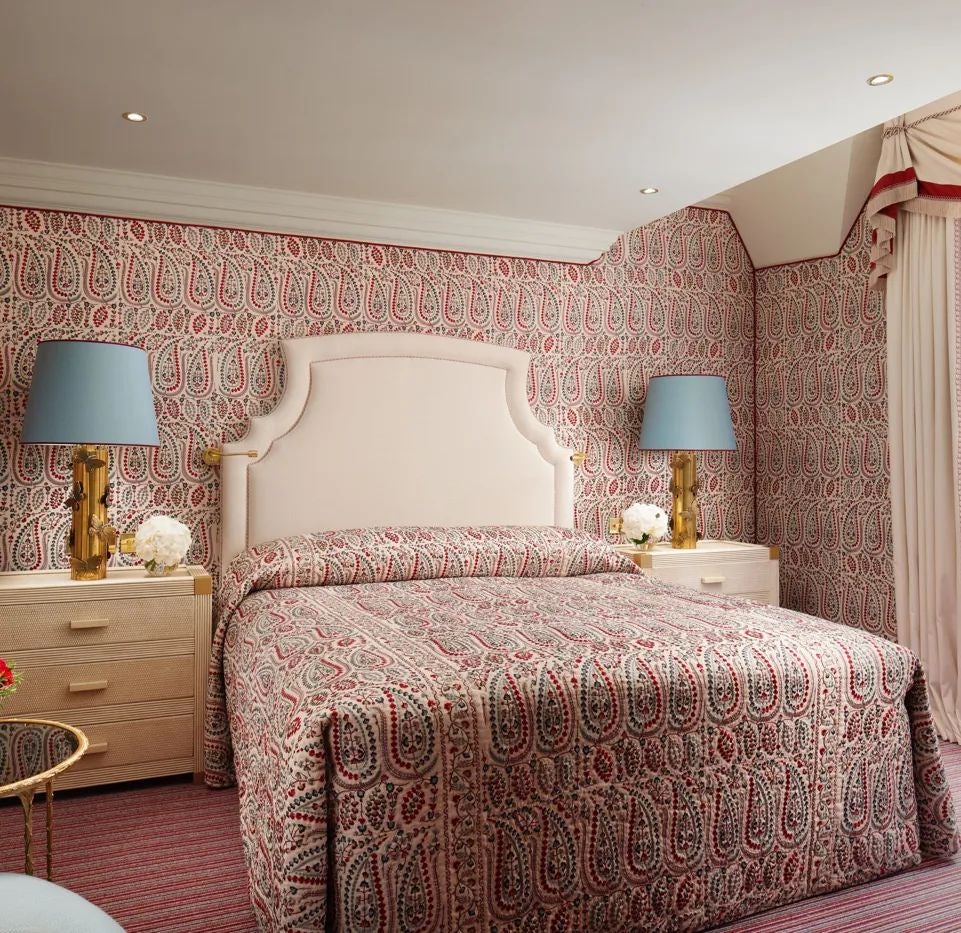 Elegant deluxe hotel room with plush bedding, ornate furnishings, and soft neutral tones at a luxurious UK boutique accommodation near Hyde Park