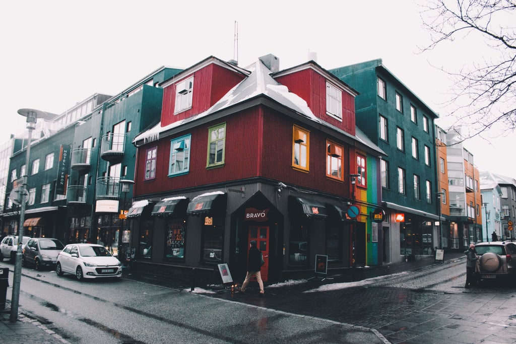 Colorful Nordic cityscape with vibrant rooftops, distant mountains, and modern architecture blending traditional Icelandic charm in Reykjavík's picturesque urban landscape