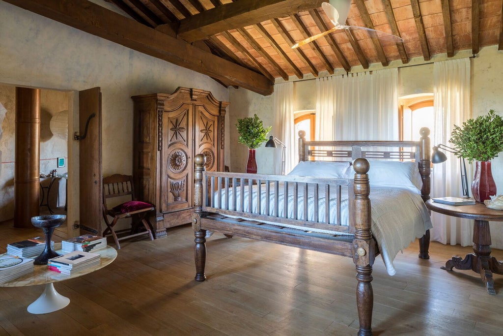 Elegant Tuscan suite with rustic stone walls, plush king bed, antique wooden furniture, and panoramic views of rolling Italian countryside vineyards